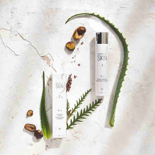 Herbivore Skin skincare products with aloe vera leaves and nuts on a light background